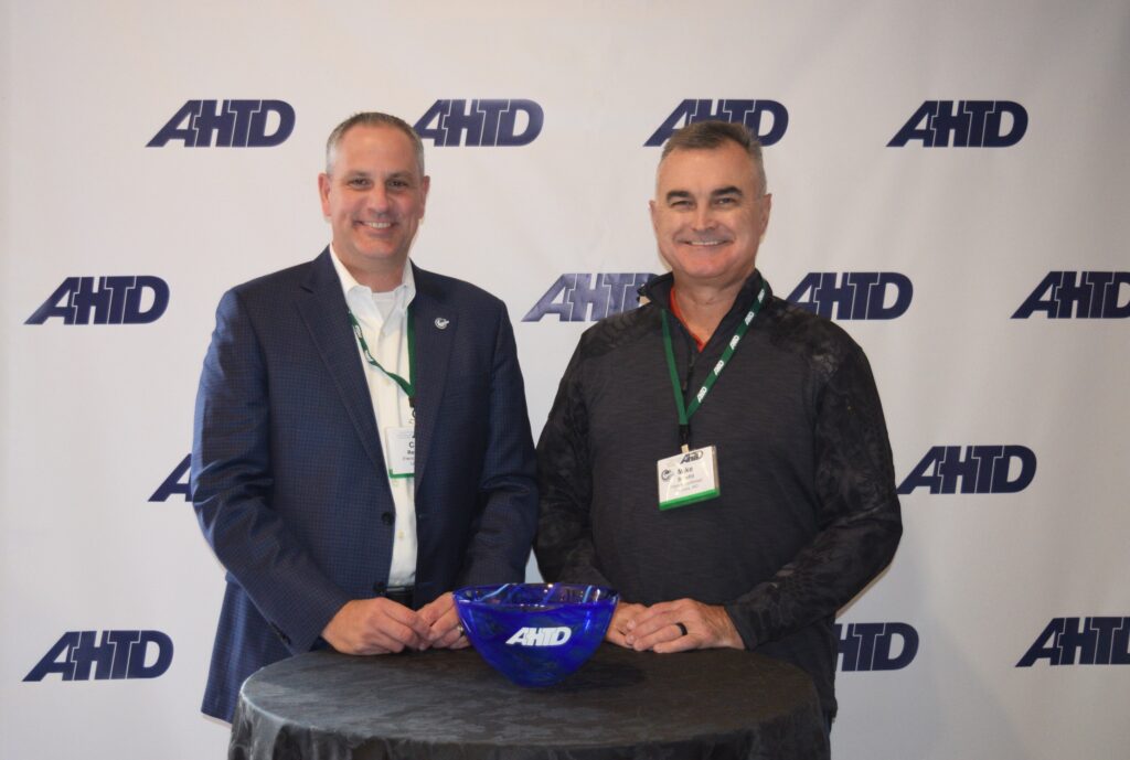 Agilix Solutions CEO Mike Stanfill accepts award from AHTD