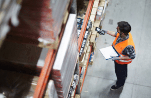 Man performing inventory management tasks in storeroom