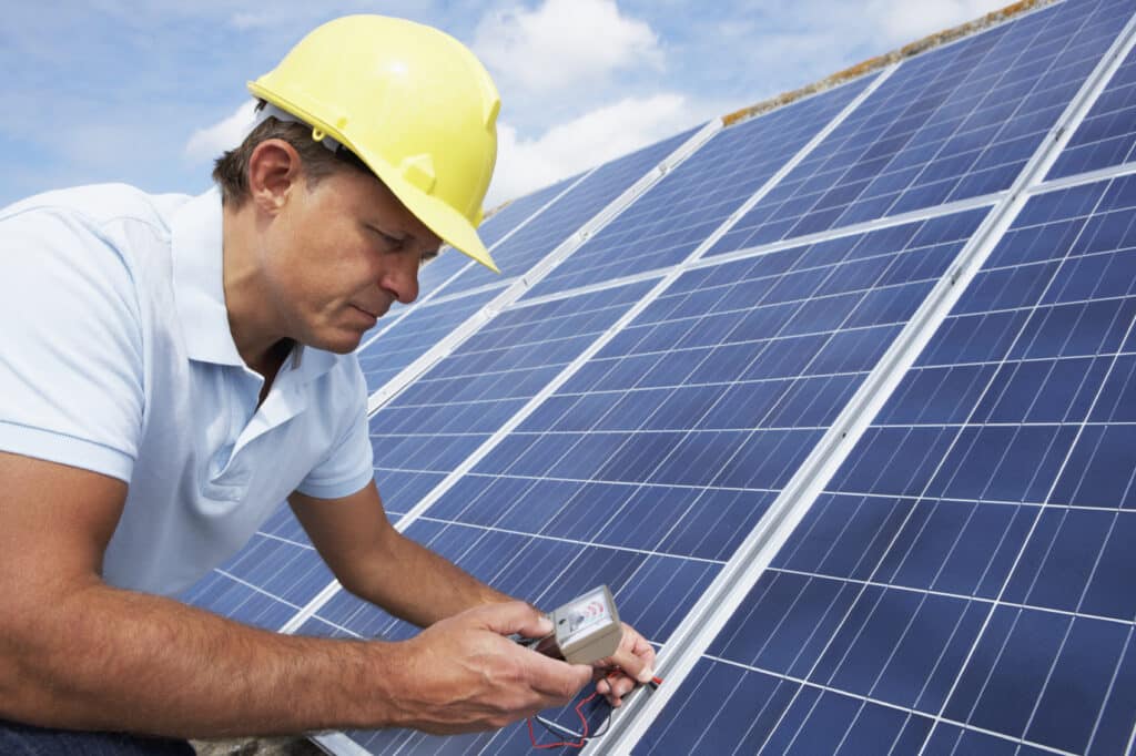 Man testing performance of solar energy technology. 