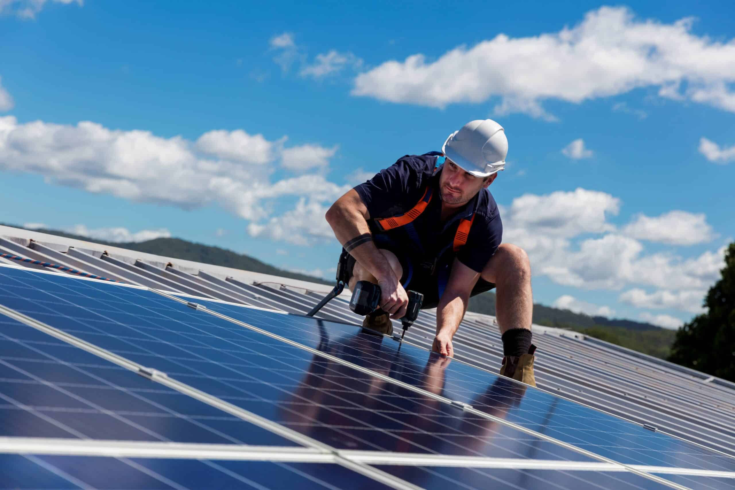 solar integration specialist installing solar energy technology at industrial facility.