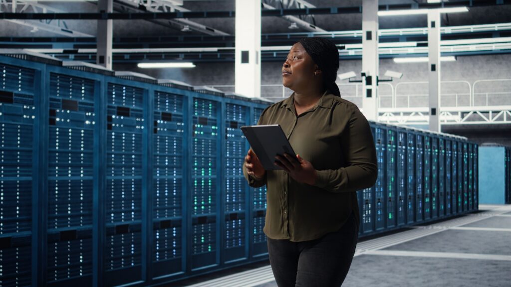 Woman walking through data center built with data center solutions from Agilix