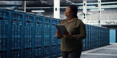 Woman walking through data center built with data center solutions from Agilix