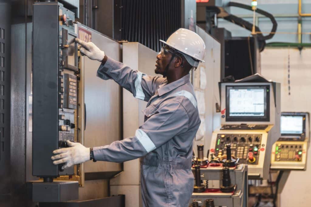 NEC 2026 changes - Electrician working in industrial environment to address code changes.