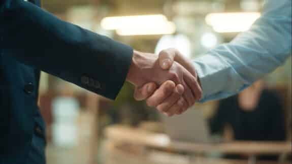 Handshake by two businessmen at Agilix Solutions