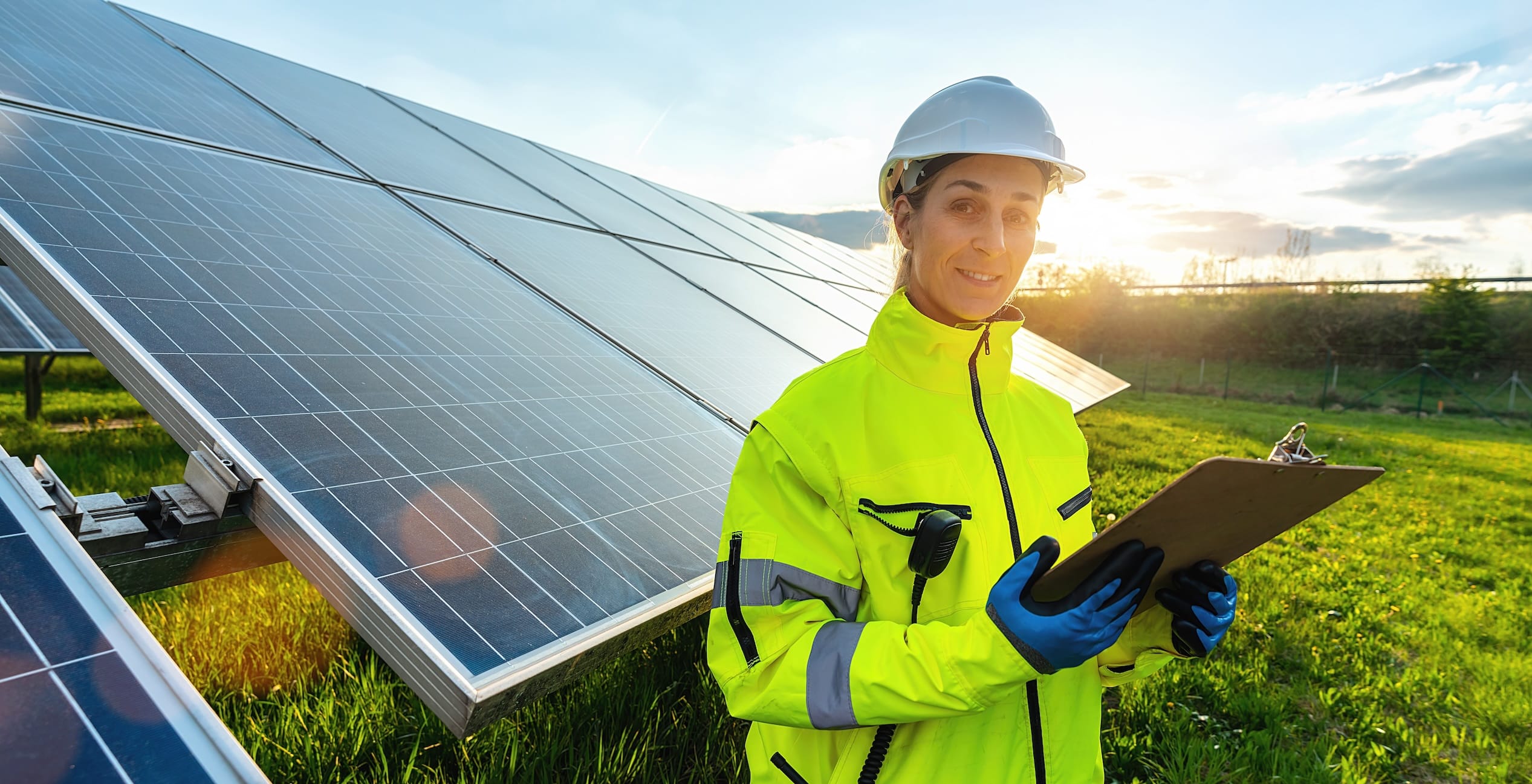 Female solar power technician leveraging insights from Siemens Sustainability report in the field.