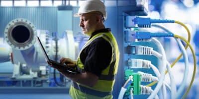 Engineer working on industrial and enterprise network convergence.