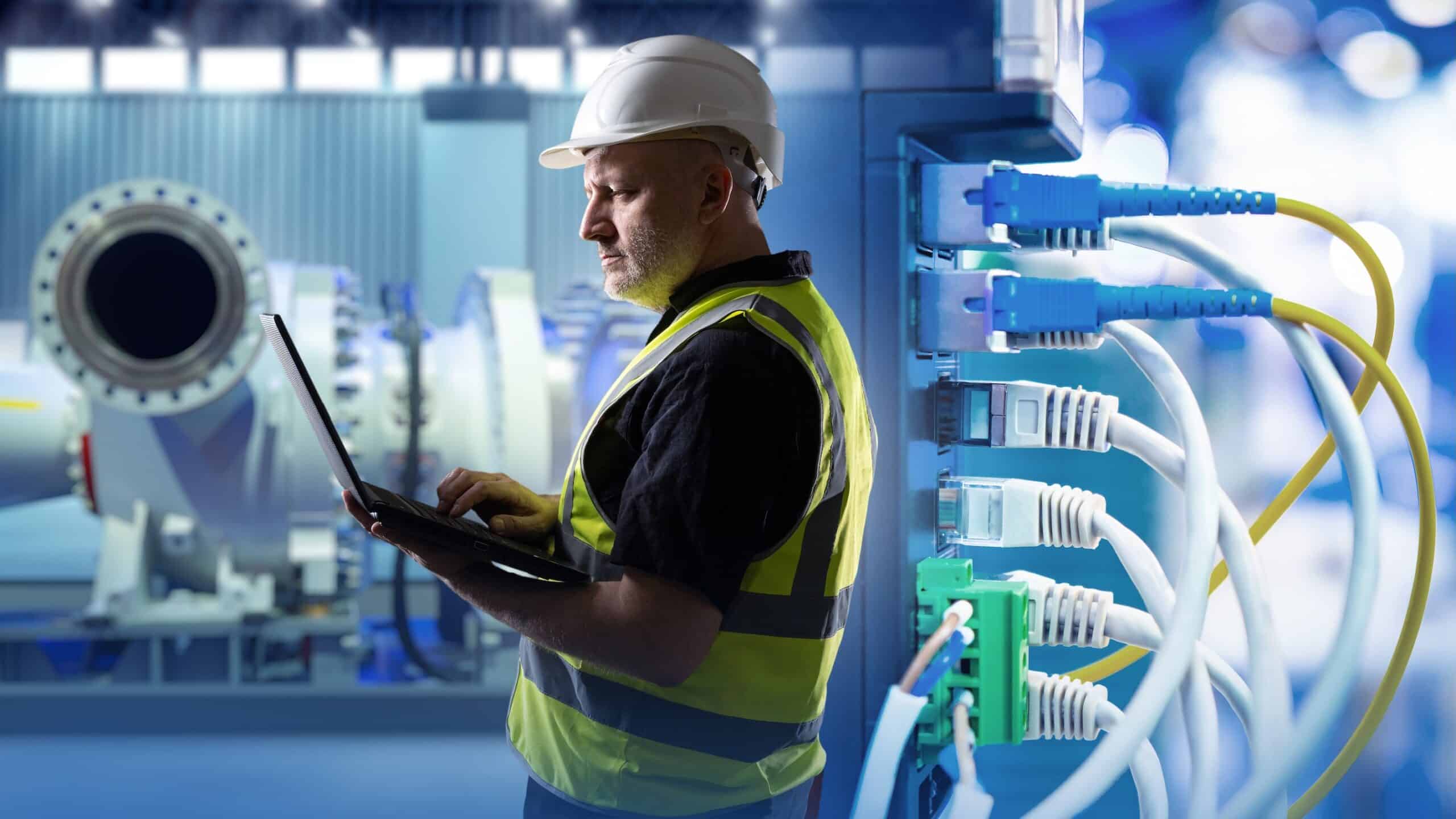 Engineer working on industrial and enterprise network convergence.